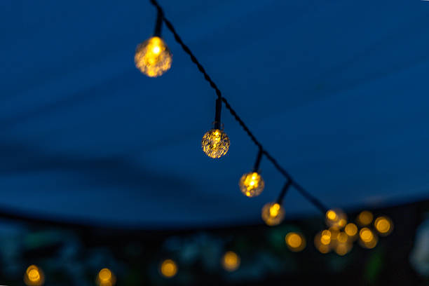 istock Light garland, small solar-powered LED bulbs on a string, garden decoration for the terrace, 2220671634