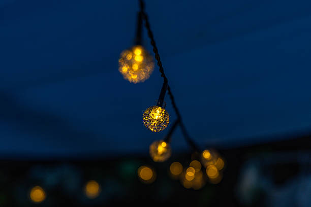 istock Light garland, small solar-powered LED bulbs on a string, garden decoration for the terrace, 2220671650