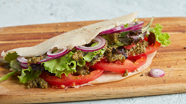istock Savory pancake with tomato, salad and onion on wooden board 2220672668