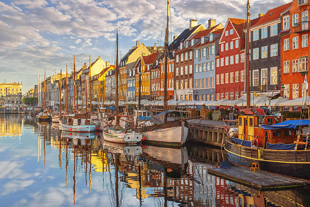 Nyhavn harbour in the morning with colorful historic buildings and sailboats in Copenhagen, Denmark stock photo