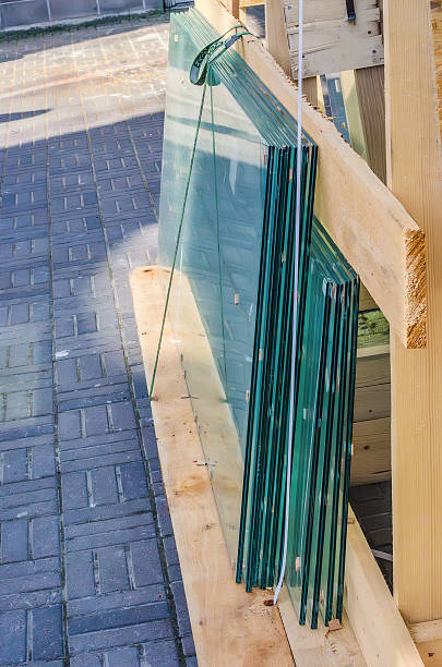 istock Sheets of glass stacked vertically in wooden construction frame 2220675117