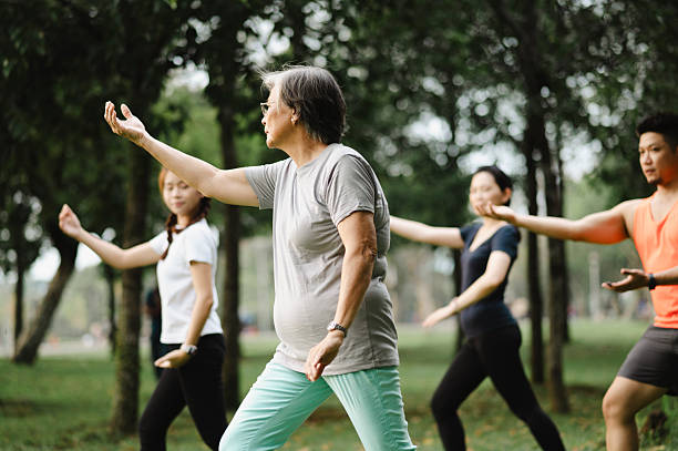 istock Active senior mother teaching her family Tai Chi. 2220675700