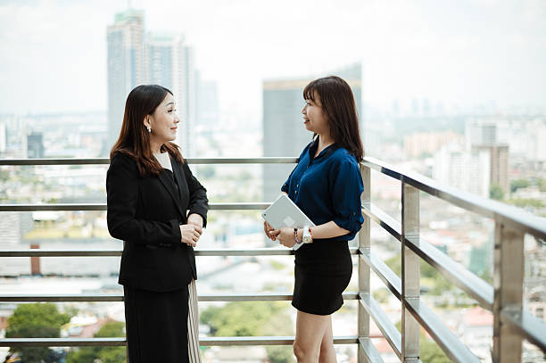 istock Colleagues Brainstorming Business Ideas on High-Rise Balcony 2220676020