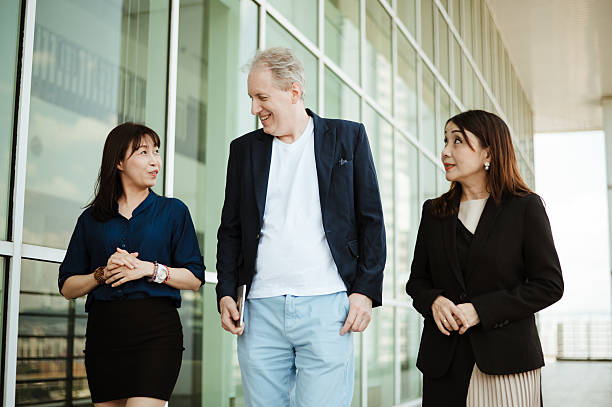 istock Three multiracial group of business person walking and talking. 2220676088