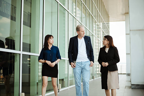 istock Three multiracial group of business person walking and talking. 2220676097