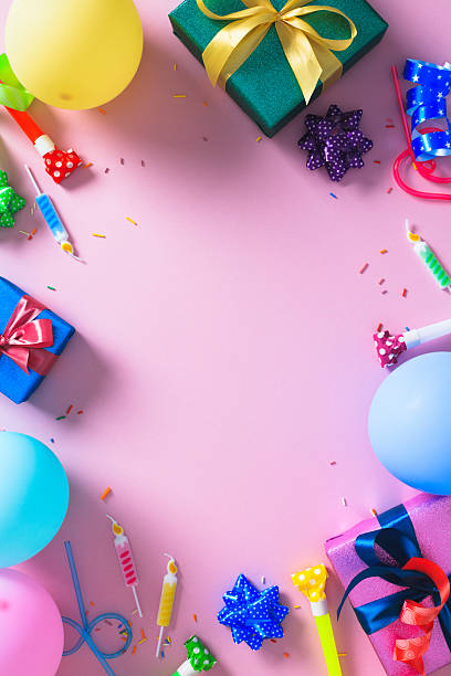 istock Birthday party frame. Flat lay composition with colorful gift boxes, balloons, and confetti on a vibrant pink background with copy space. 2220677506
