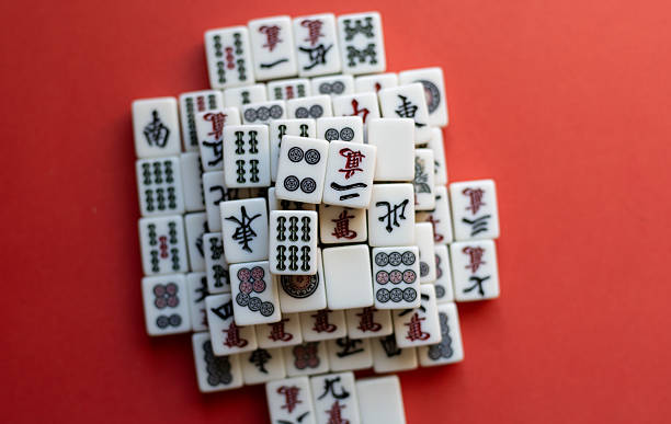 istock Mahjong tiles lined up on a red background 2220679832