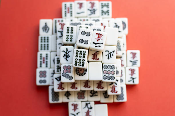 istock Mahjong tiles lined up on a red background 2220679926
