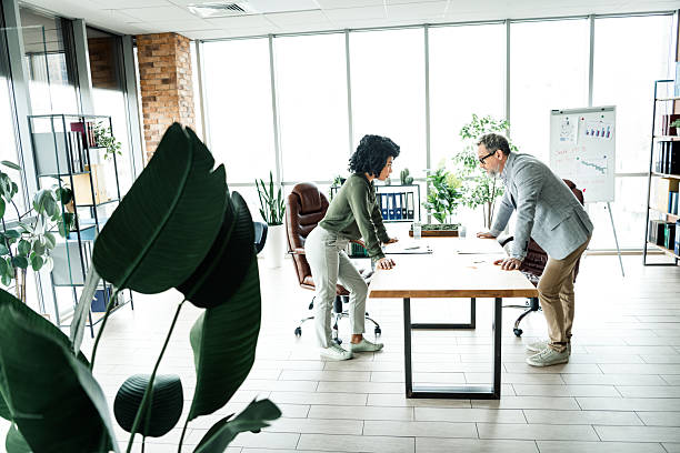 istock Collaborative teamwork in a modern office environment with diverse coworkers engaged in a professional meeting 2220681402