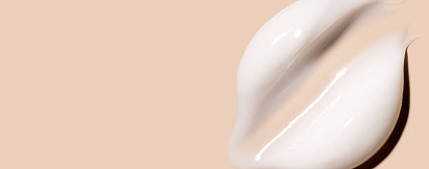 istock sample smear of creamy white texture on light beige background close up 2220682399