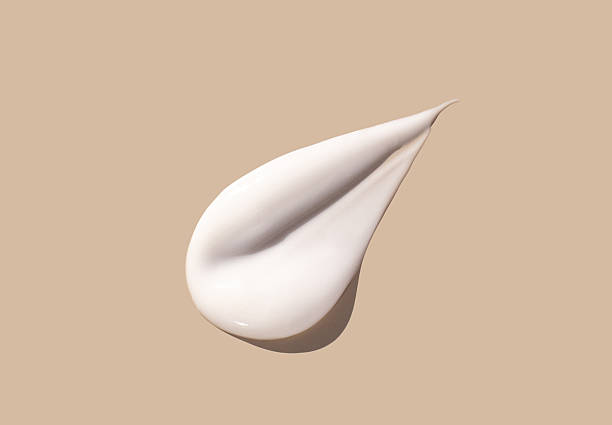istock sample smear of creamy white texture on light beige background close up 2220682401