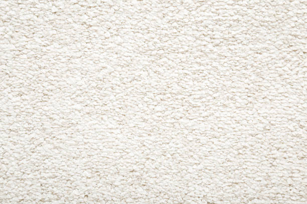 istock White new fluffy home carpet background. Closeup. Empty place for text. Top down view. 2220683728