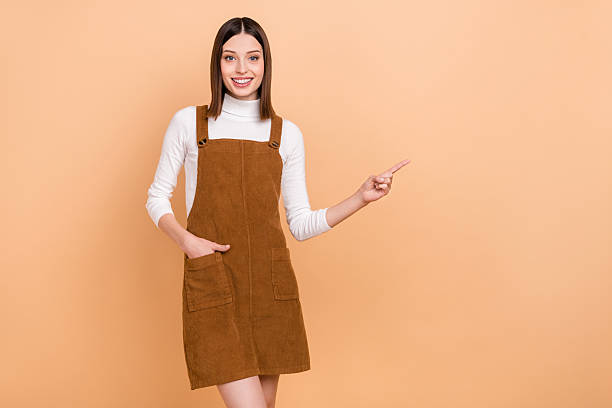 istock Portrait of attractive cheerful girl demonstrating copy empty space solution decision isolated over beige color background 2220683868