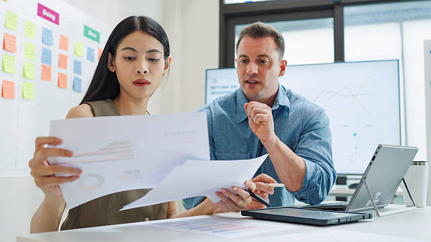 istock Diverse Collaborative Business people meeting with Digital Devices computer brainstorming the financial report paperwork document analyzing data or planning strategies displays a graph or chart in a modern business technology 2220684129