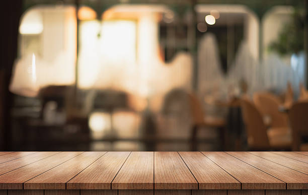 istock Empty wooden table top with lights bokeh on blur restaurant background. 2220684130