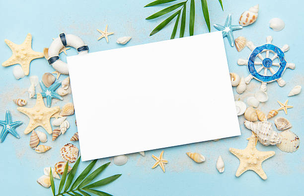 istock Blank card surrounded by seashells and starfish on sandy beach 2220684286