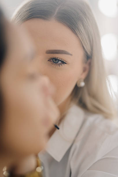 istock Makeup artist applying makeup on model's face in beauty salon 2220684372