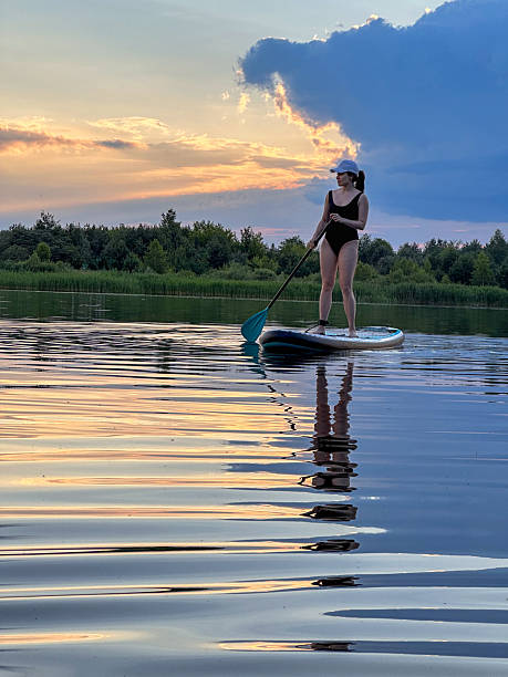 istock Paddleboarding at Sunset on a Tranquil Lake 2220685339