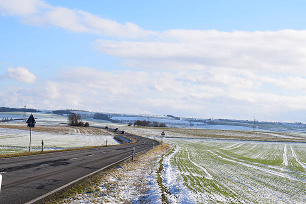 istock cleared road through snowy land 2220688516