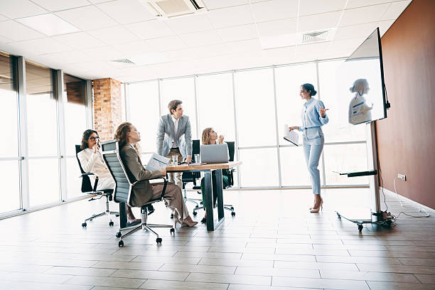 istock Professional Team Collaborating in a Modern Office Setting with Corporate Presentation and Strategic Planning 2220689279