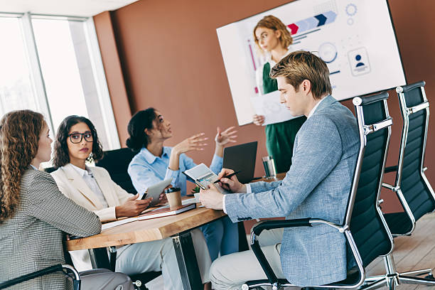 istock Diverse business team collaborating in modern office setting during an important strategy meeting, highlighting teamwork and interaction 2220689395
