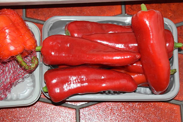 istock red long paprika in plastic pots 2220690392