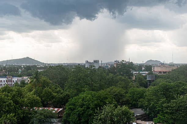 istock Dark clouds gather over the city as rain begins to fall 2220690778