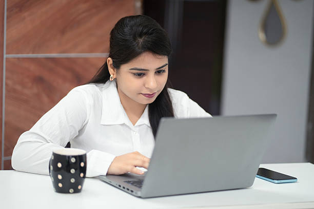 istock Focused Indian Businesswoman Working on Laptop in Office Setting 2220693986