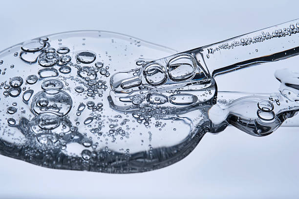 istock The texture of the serum with bubbles spilling onto the blue surface. 2220697080