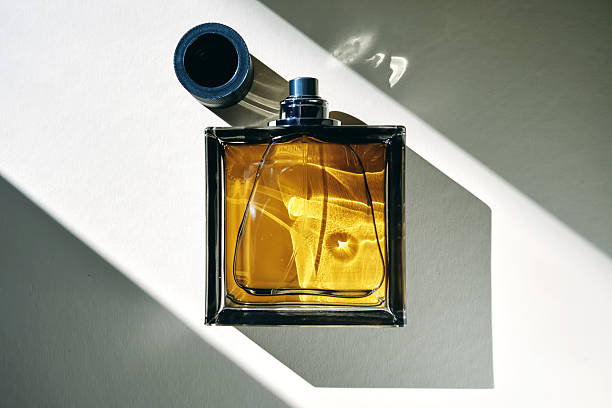 istock A golden bottle of perfume in a sunbeam. 2220697718