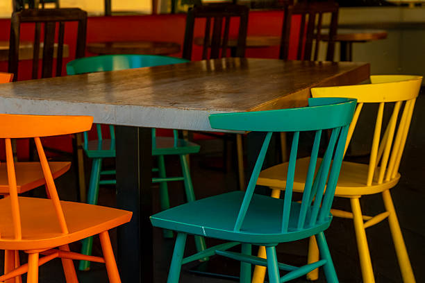 A vibrant caf interior featuring colorful chairs and inviting tables, ideal for social gatherings