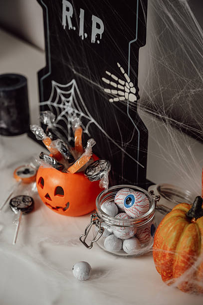istock Vertical dark and spooky halloween banner with pumpkins, candies, spider web etc 2220698052