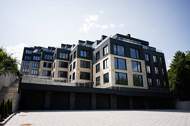 istock Modern residential building with large glass windows under a sunny sky 2220698620