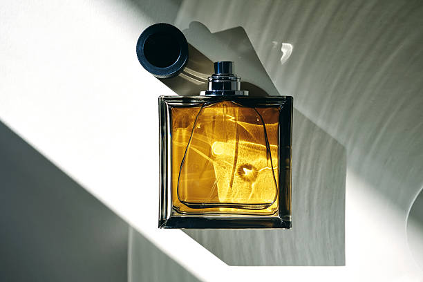 A product on display in a colorful studio environment. The beauty product on display is a glass perfume bottle with a luxury feeling. Created in 3D.
