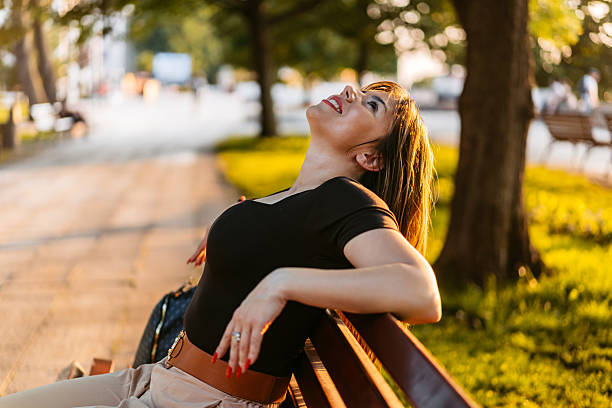 Young beautiful woman relaxing on a park bench.