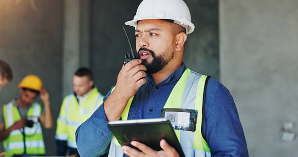 istock Building, radio and tablet with developer man on site for civil engineering or development. App, blueprint and communication with construction worker person on worksite for project management 2220706668