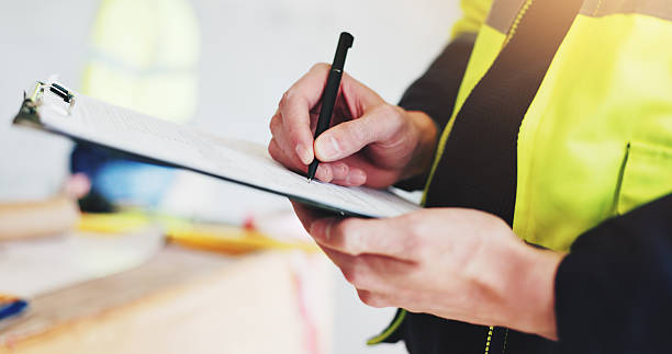 istock Man, hands and contractor with clipboard for construction, industrial career and building renovation of development. Engineer, architect and site inspection for maintenance or infrastructure project 2220706692