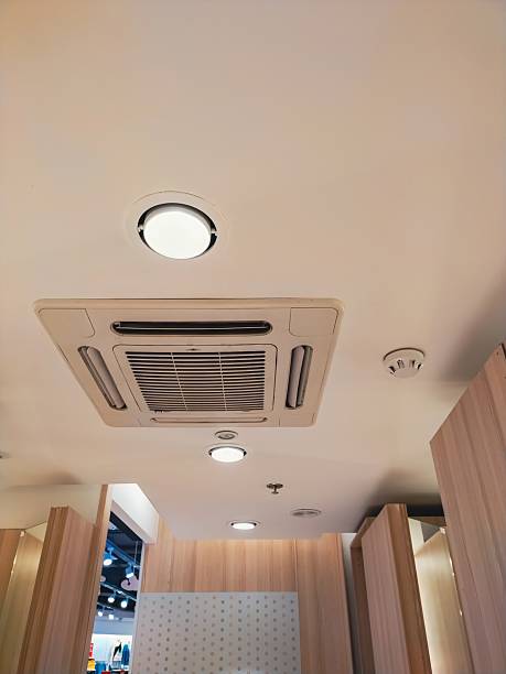 istock Ceiling-mounted air conditioning unit and recessed lights in an interior commercial space. 2220707392