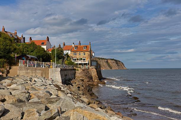 istock A coastal scene featuring rocky shores, buildings perched on cliffs 2220709930