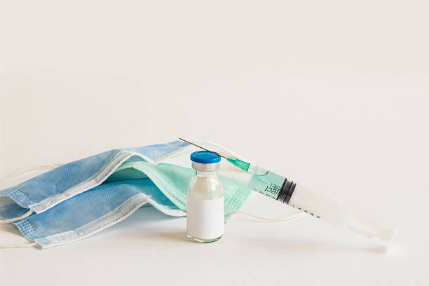 istock Medical mask with bottle and injector 2220710012