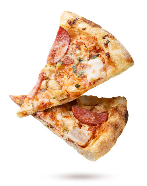 Two pieces of pizza flying close-up on a white. Isolated