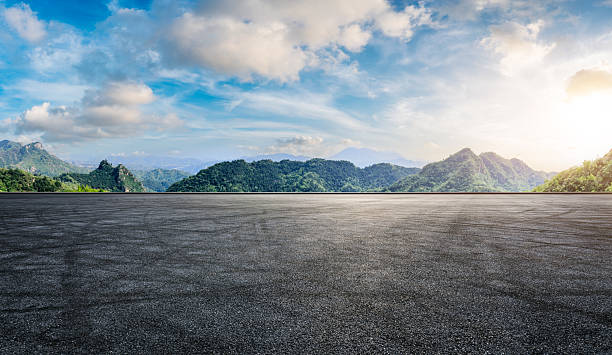 istock Asphalt road and green mountain with beautiful sky clouds in summer 2220715910