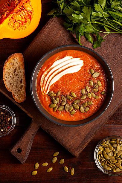 istock Pumpkin Soup with Cream, Seeds, and Rustic Bread 2220717973