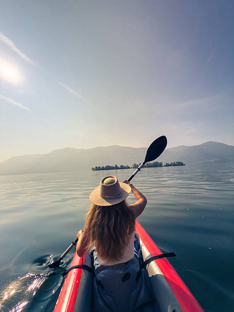 istock Woman Kayaking on Tranquil Lake 2220718918