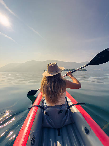 istock Woman Kayaking on Tranquil Lake 2220718947