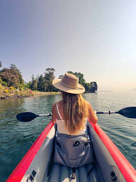 istock Woman Kayaking on Tranquil Lake Under Clear Sky 2220719057