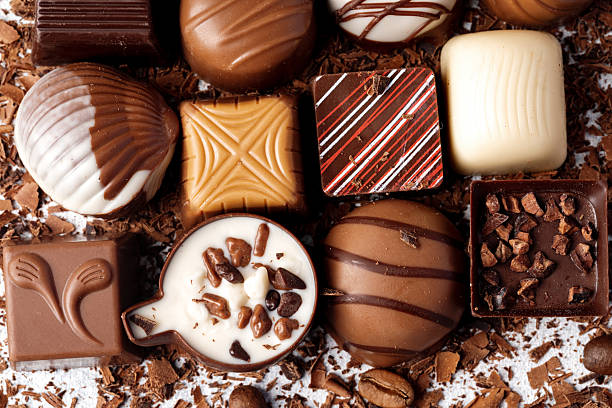istock Chocolate candies and chocolate pieces pile for background 2220721085