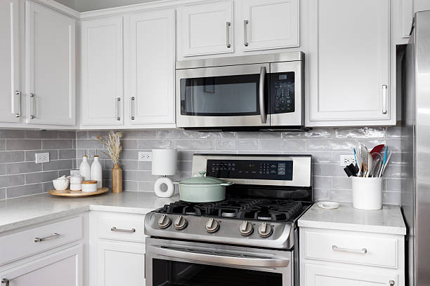 istock A white kitchen with a grey subway tile backsplash and stainless steel appliances. 2220723586