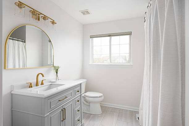 istock A bathroom with a grey cabinet and gold accents. 2220723659