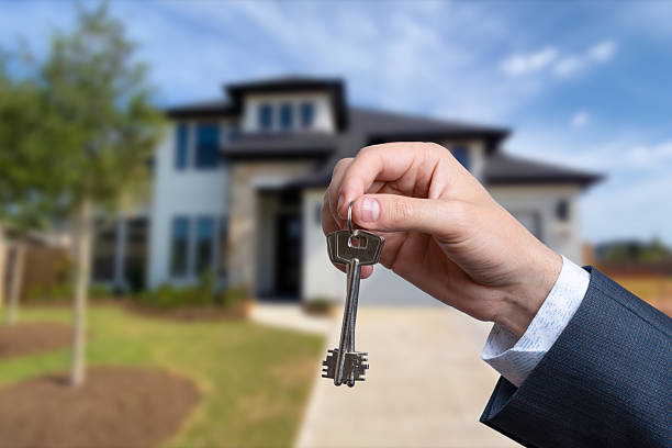 istock Landlord unlocks the house key for new home. 2220726556